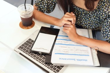 Closeup workspace of a person signing up for health insurance benefits