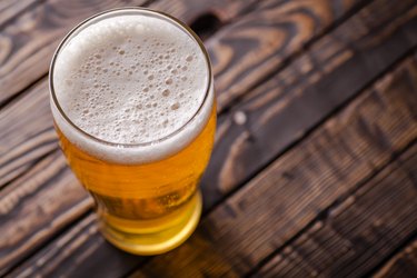 Pint of light beer on wooden table