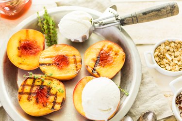 Organic grilled peaches with ice cream on top