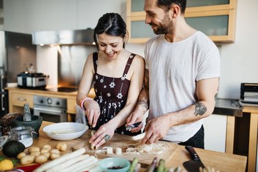 Mature couple preparing food for dinner