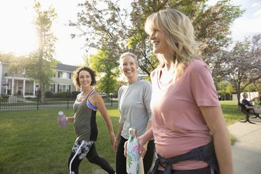 People walking in a group, exercising in sunny park