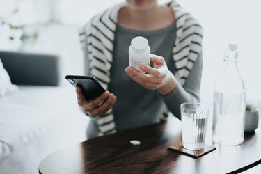 Person holding a bottle of gaba supplements