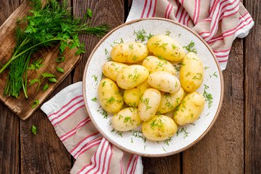 Boiled new potato with butter, dill and green onion