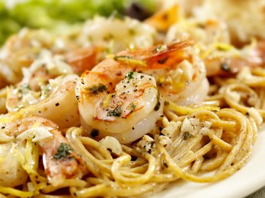 Slow cooker seafood recipe of shrimp scampi on a white plate