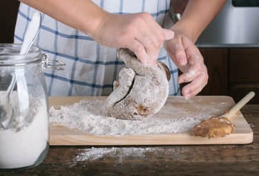 Girl's hands kneading dough for gingerbread.