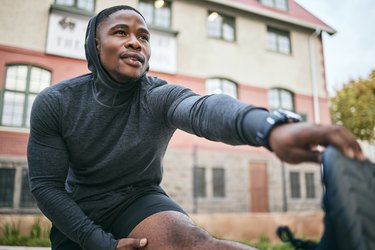 Adult stretching before a run, wearing memorial day fitness sale clothes.