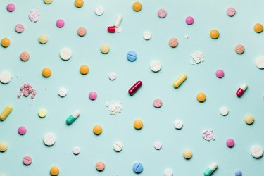 colorful multivitamins in a pattern on a blue background