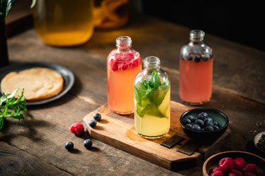 assortment of homemade kombucha in glass bottles set