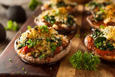 Homemade Baked Stuffed Portobello Mushrooms on wood board