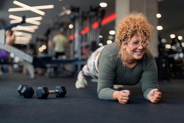 Athlete performing plank at the gym.