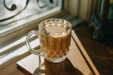 inulin-rich chicory coffee in Glass Mug Casting a Shadow on a Wooden Table