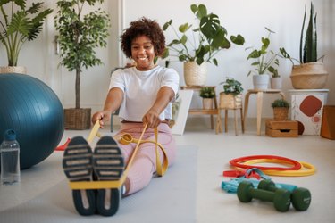 Person working out with resistance bands in living room to demonstrate a resistance band workout for better mobility