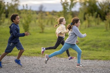 A group of children running outside