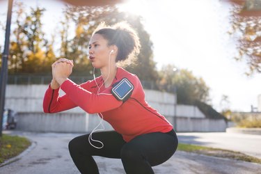 Woman doing squats outside