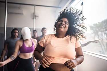 Young people dancing in class happy