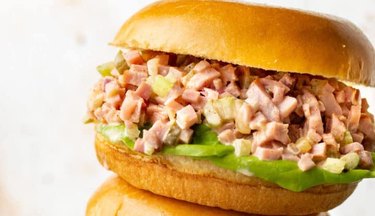 Ham Salad on a bun with lettuce on a white background