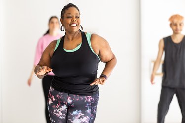 People in fitness studio dancing to demonstrate a full-body dance sculpt-inspired workout