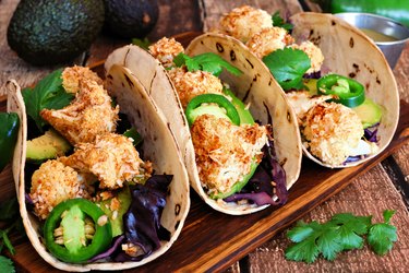 Healthy coconut cauliflower tacos, close up on wood